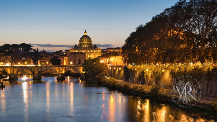 Breathtaking sunset view from Ponte Sant'Angelo, showcasing the majestic St. Peter's Basilica in the background, with vibrant colors reflecting off the Tiber River.